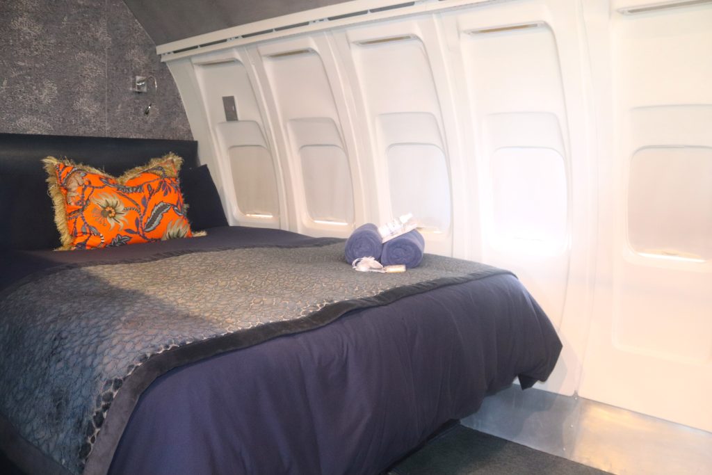 A queen-size bed inside at Aviator Boutique Hotel